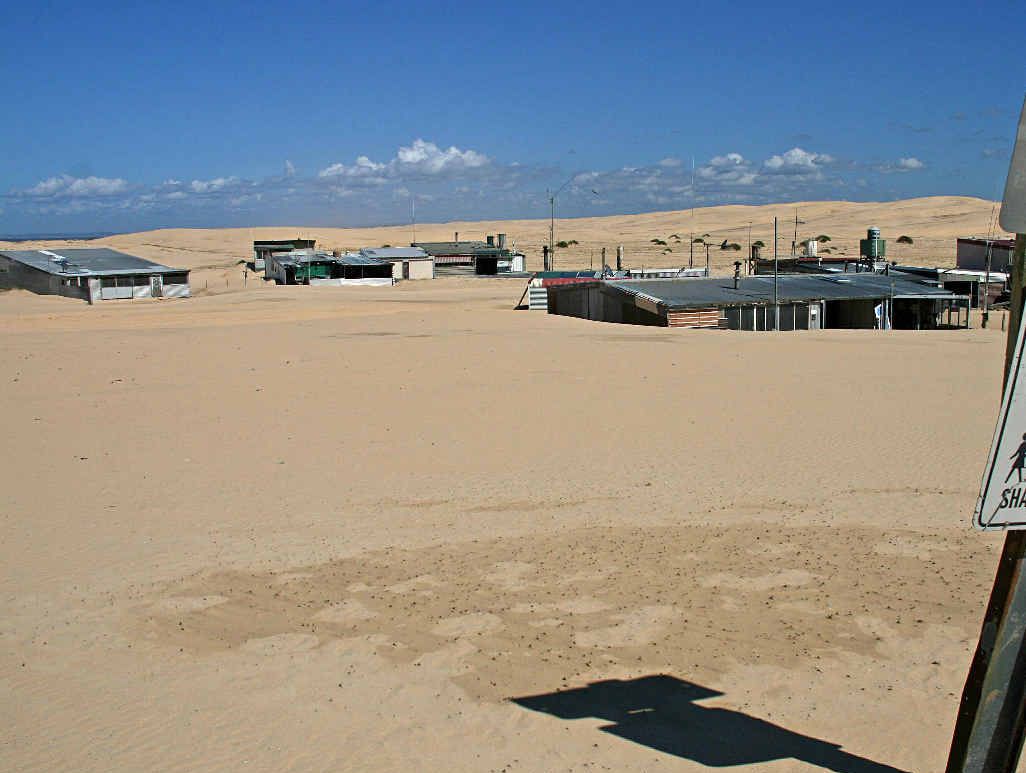 Tin City – a daily battle with the ever-shifting Stockton Beach sand dunes. Tin City – a daily battle with the ever-shifting Stockton Beach sand dunes.